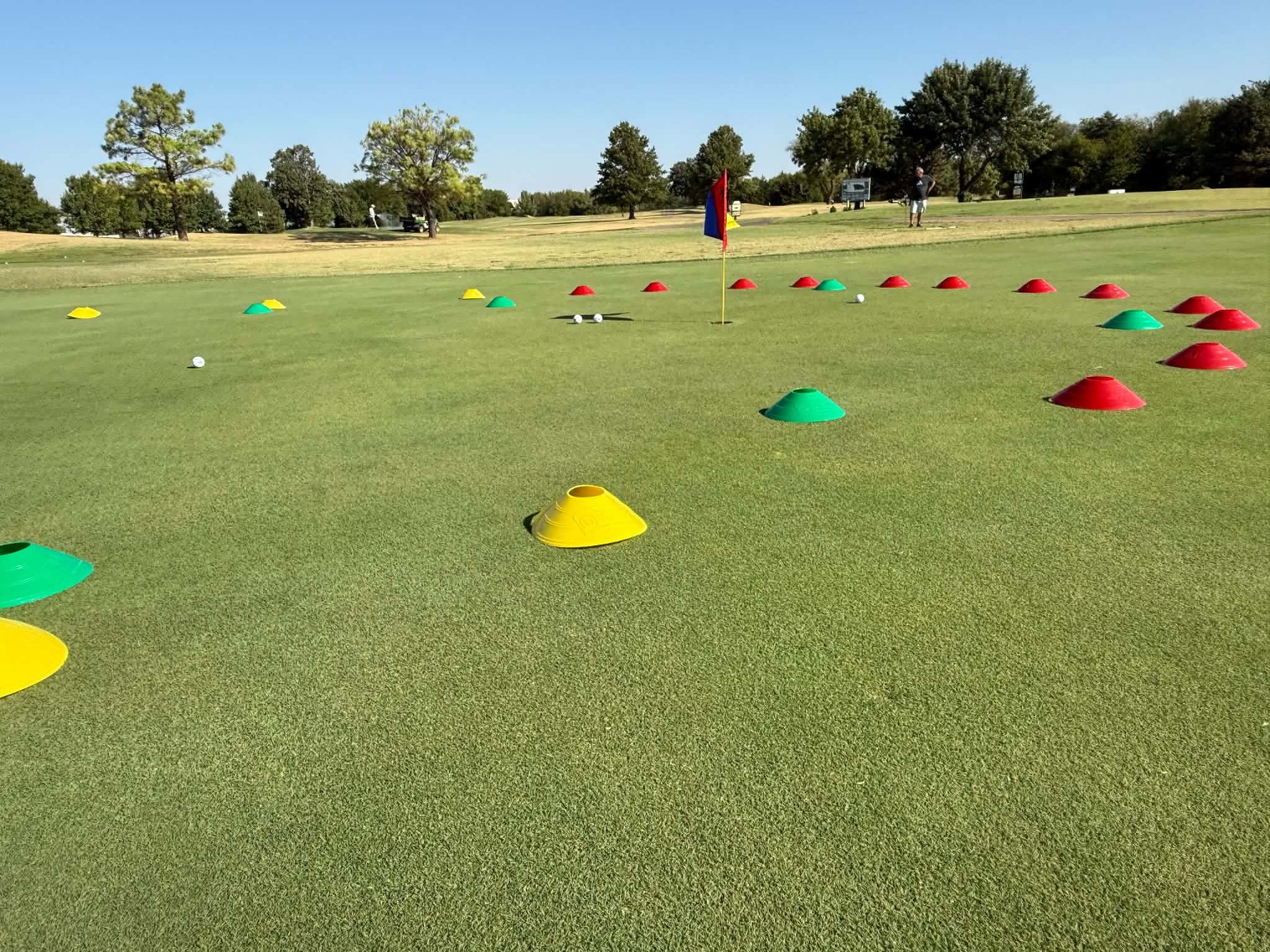 Putting practice area with colorful cones and golf balls