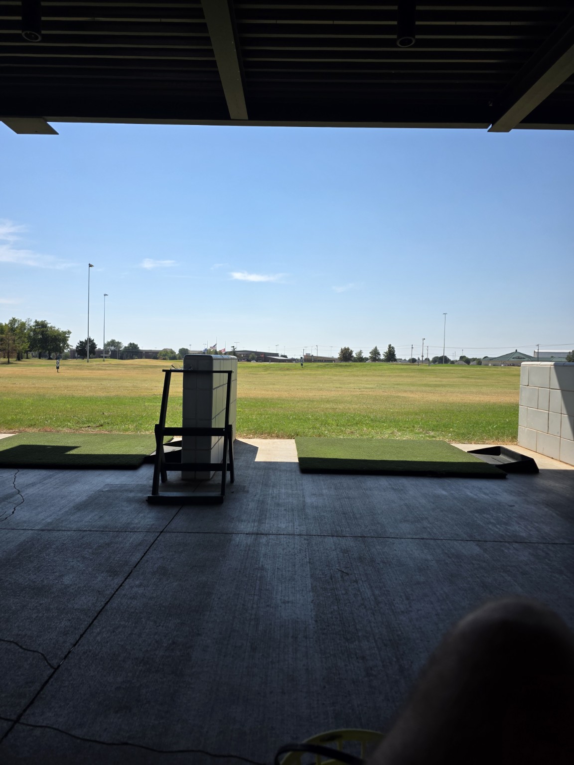 Covered golf driving range practice bays